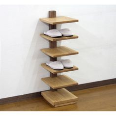 there is a wooden shelf with shoes on it