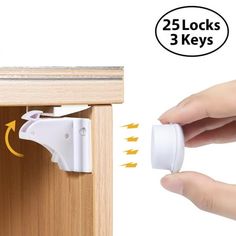 a hand holding a white plastic object over a wooden cabinet door with two locks on it