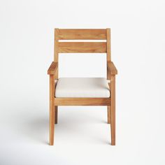 a wooden chair with a white cushion on the back and armrests, against a white background