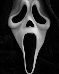 a white scream mask with black eyes and mouth