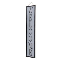 a welcome sign hanging from the side of a wall with an inscription on it that says welcome