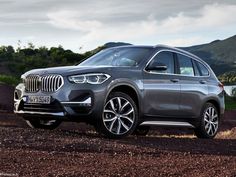 the new bmw x5 suv is parked on a dirt road