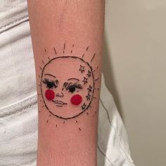 a woman's arm with a sun and moon tattoo on it