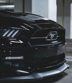 the front end of a black mustang car