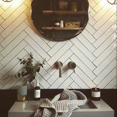 a bathroom sink with a towel on the counter next to it and a mirror above it