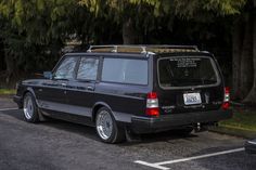 a black station wagon parked in a parking lot