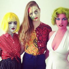 three women with painted faces posing for the camera