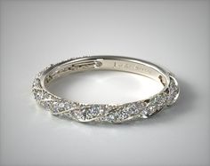 a diamond wedding band is shown in white gold