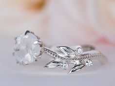 a white diamond ring with leaves on it