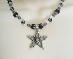 "This beautiful necklace has black pearl beads, black beads with silver engraved stars, seed beads, sterling silver plated filigree beads, pewter silver bead caps and a pewter silver pentagram. 18\" long. Sterling silver plated toggle clasp." Gothic Star-shaped Jewelry For Festivals, Handmade Black Star Necklace, Gothic Silver Beaded Necklaces With Black Beads, Gothic Silver Necklace With Black Beads, Gothic Silver Beaded Necklace Perfect For Gifts, Silver Gothic Necklace With Black Beads, Silver Gothic Beaded Necklace For Gift, Silver Gothic Beaded Necklace As Gift, Black Spiritual Star-shaped Jewelry