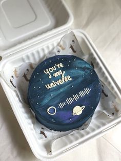 a space themed cake in a foam container with the words you're my universe written on it