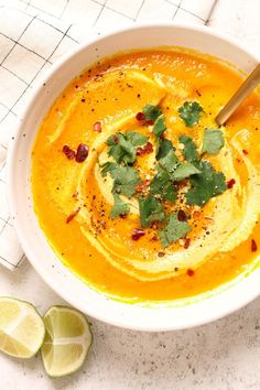 a white bowl filled with soup and garnished with cilantro