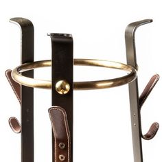 a close up of a pair of scissors on a stand with leather straps and handles