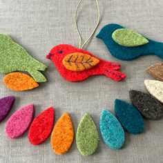 felt bird ornaments are arranged in a circle