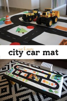 a play mat with construction vehicles on it and the words cut & paste city car mat