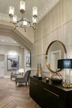 a living room filled with furniture and a chandelier