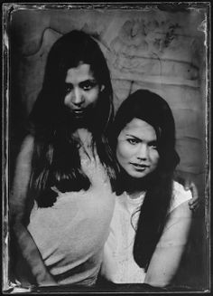 an old photo of two women with long hair