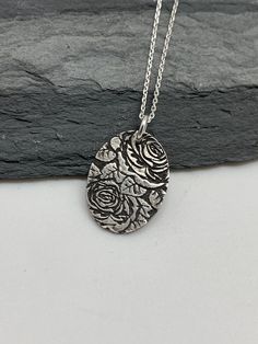 This small oval floral rose necklace has been entirely handmade using .999 fine silver. It has been cut from fine silver precious metal clay, textured, fired and oxidized. The pendant hangs from a sterling silver diamond cut cable chain. This fine silver oval pendant features an embossed floral rose textured pattern. Pendant size: approximately 3/4 x 3/4 inches Chain length: adjustable at 16 and 18 inches can also be customized to whatever length needed The necklace is sent in a gift box. This j Layered Necklaces Boho, Art Nouveau Necklaces, Moon Necklace Silver, Vertical Bar Necklace, Silver Bar Necklace, Layered Necklaces Silver, Precious Metal Clay, Charm Necklace Silver, Rose Necklace