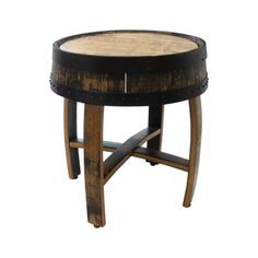 a round wooden table with black metal trimmings and an aged wood frame on the top