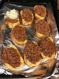 six sloppy joes are sitting on top of tin foil and ready to be baked