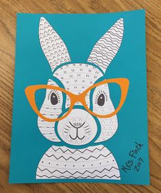 a drawing of a rabbit with glasses on it's head, sitting on a wooden table