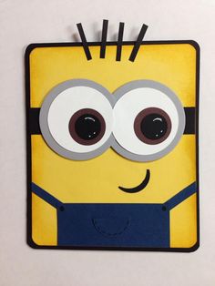 a paper cut out of a minion with googly eyes