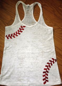 a women's tank top with baseball stitches on the front and back, sitting on a wooden floor