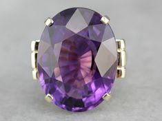 This is a stunning stone, with a rich color and a sophisticated cut. This natural, well-cut amethyst at the center glimmers with its medium-deep eggplant purple color that flashes with pops of violet and raspberry. We've set this pretty gem into a vintage mounting of yellow gold. Easy to wear, this sits comfortably on the finger and is a nice, bold size that is sure to make a statement! Metal: 14K Yellow Gold Gem: Amethyst 19.50 Carats Gem Measurements: 15.9 x 20.8 mm, Oval Ring Size: 5.50 Marks Oval Stone Ring, Amethyst Cocktail Ring, Right Hand Ring, Vintage Cocktail Ring, Right Hand Rings, Eggplant Purple, Hand Ring, Oval Ring, Amethyst Jewelry