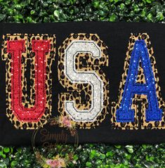 the word usa made out of sequins and leopard print on a black background