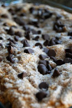 a cookie with chocolate chips on top in a glass baking dish, ready to be eaten