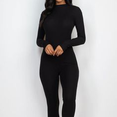 This black jumpsuit features a sleek skinny leg design, perfect for elongating the body and creating a slimming silhouette. Made with high-quality fabric, it provides both comfort and style for a versatile and put-together look. Black Stretch Jumpsuits And Rompers In Elastane, Sleek Stretch Long Sleeve Jumpsuits And Rompers, Sleek Black Long Sleeve Jumpsuits And Rompers, Trendy Solid Elastane Jumpsuits And Rompers, Trendy Elastane Jumpsuits And Rompers, Elegant Stretch Jumpsuits And Rompers For Fall, Black Stretch Jumpsuits And Rompers For Work, Sleek Black Stretch Jumpsuits And Rompers, Chic Black High Stretch Unitard