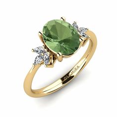 a gold ring with an oval green stone and three diamonds