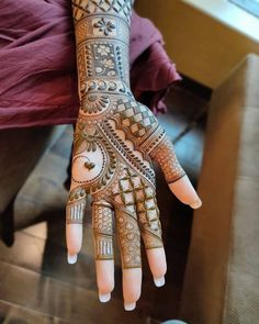 a woman's hand with hennap on it, showing the intricate design