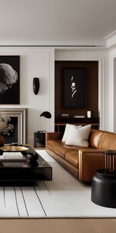 a modern living room with leather furniture and art work on the wall behind the fireplace