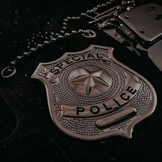 a police badge is shown on a black jacket with a keychain and chain