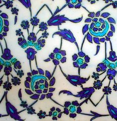 a blue and white plate with flowers on it's side, in the shape of an ornament