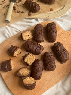 there are chocolates and peanut butter on the cutting board