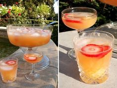 two glasses filled with drinks sitting on top of a table next to another glass full of liquid