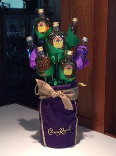 a purple bag filled with liquor bottles on top of a table