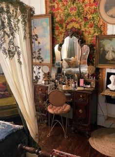 a room with many pictures on the wall and a chair in front of a mirror