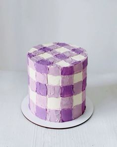 a purple and white cake sitting on top of a plate