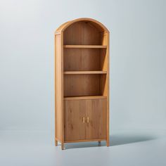 a wooden bookcase with two doors on the front and one door open to reveal a shelf