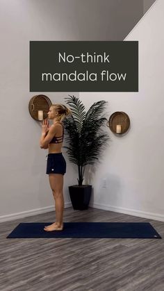 a woman standing on a yoga mat in front of a wall with the words, no - think mandala flow