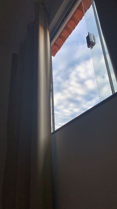 an open window with the sky in the background