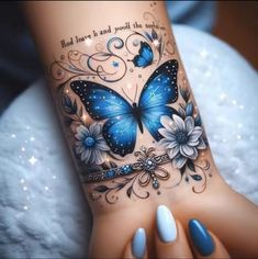 a woman's arm with blue butterflies and flowers on it