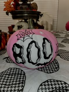 a pink pumpkin decorated with black and white designs