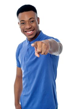 a man pointing at the camera while wearing a blue shirt