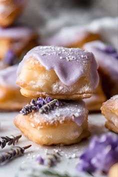 lavender sprinkled donuts stacked on top of each other