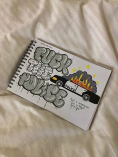 an open notebook with graffiti writing on it