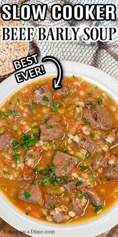 a bowl of beef barley soup with the words slow cooker beef baby soup above it